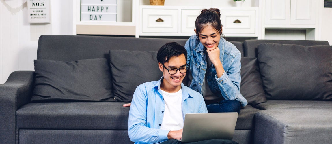 man and woman looking at a computer