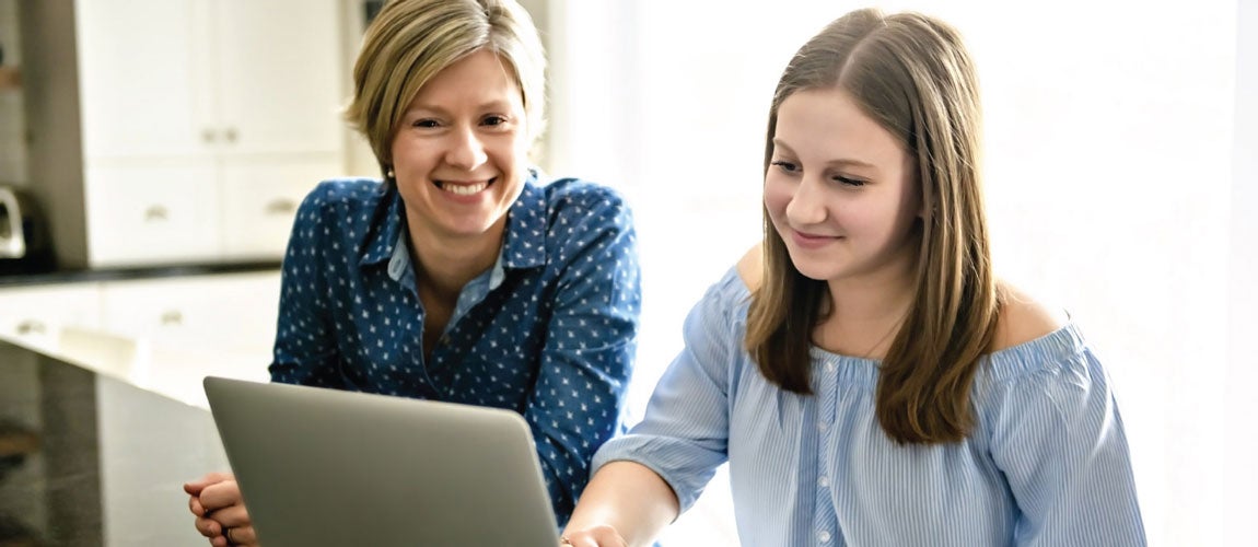 mom and daughter looking at a laptop