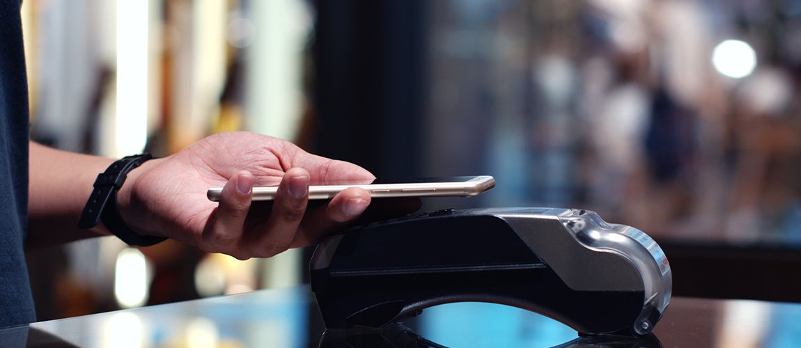 Using a digital wallet to pay for items at checkout.