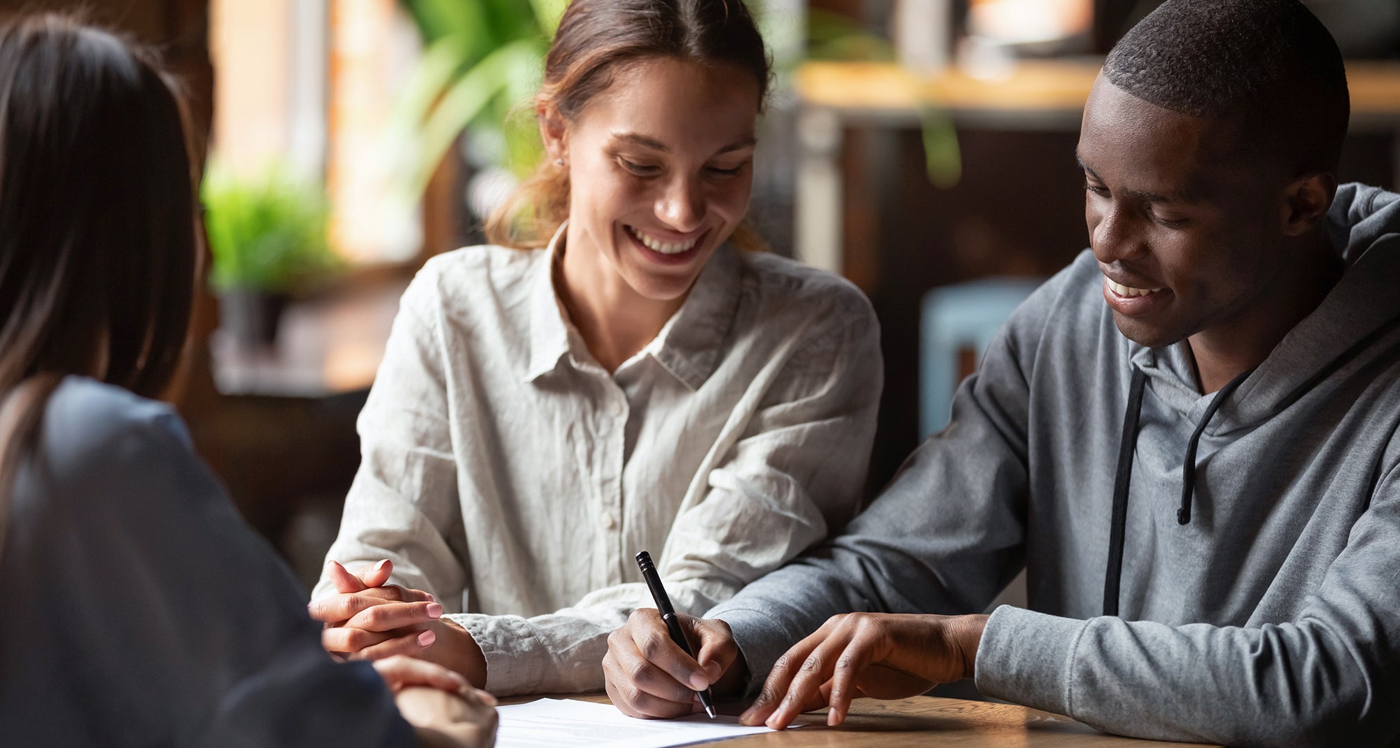 Couple signing Mortgage Papers