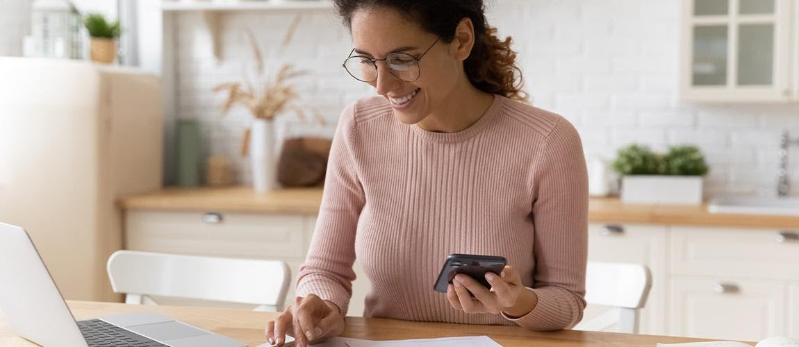 Woman is happy to see that she is staying on track to meet her savings goals