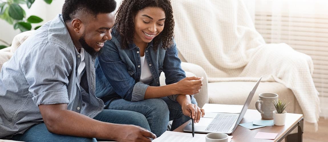 A couple happily reviews finances together