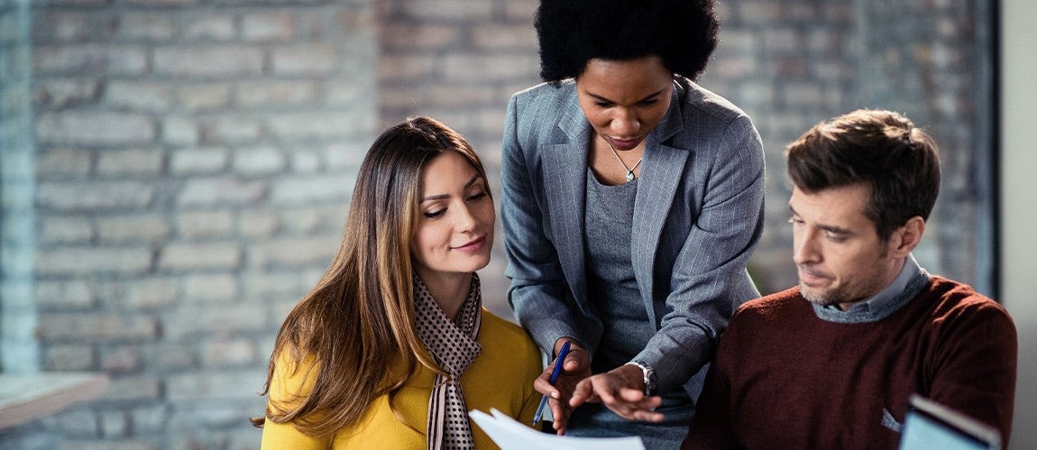 A mortgage loan officer explains the process of obtaining a mortgage to a couple.