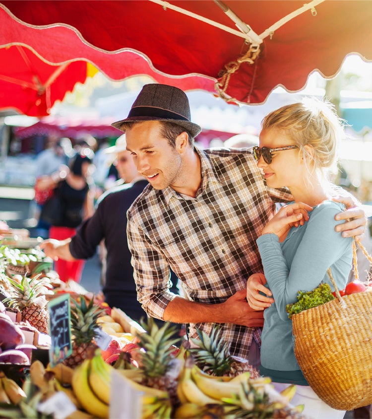 A couple strolling through a farmers market