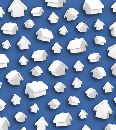 white monopoly house game pieces on blue background