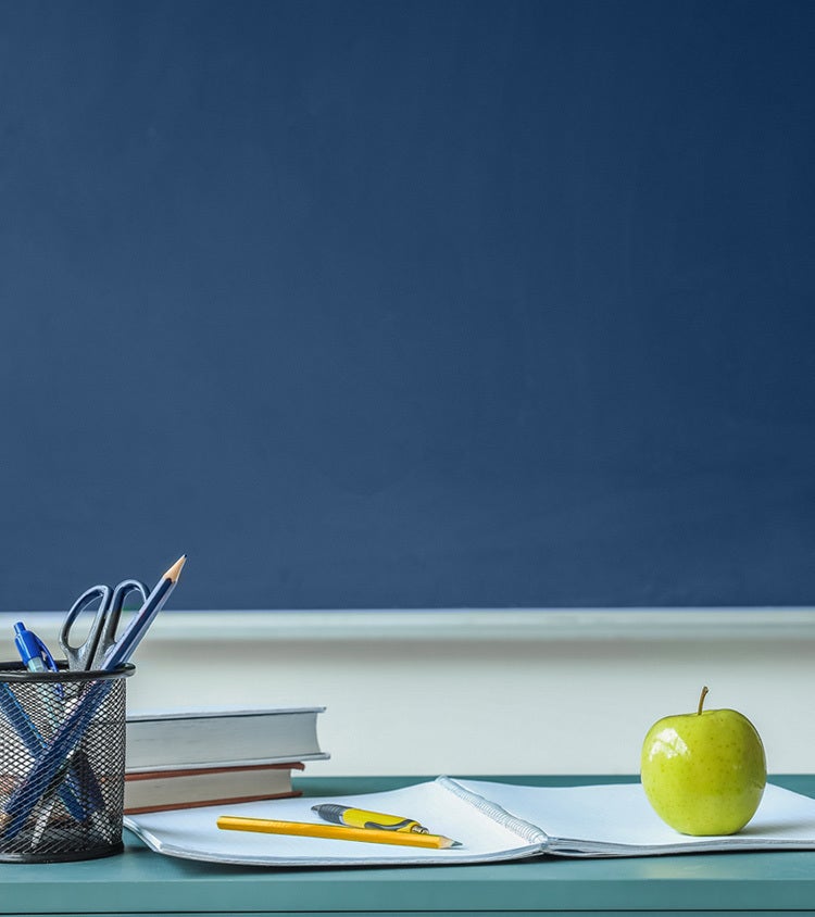 teachers-desk-with-papers-and-an-apple