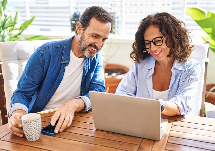 Man and woman looking at a laptop