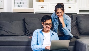 man and woman looking at a computer