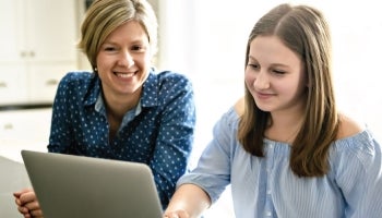 mom and daughter looking at a laptop