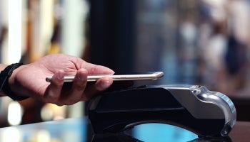 Using a digital wallet to pay for items at checkout.