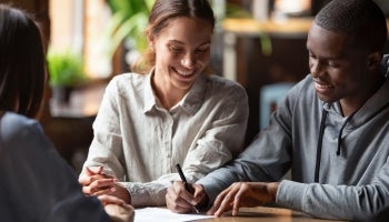 Couple signing Mortgage Papers