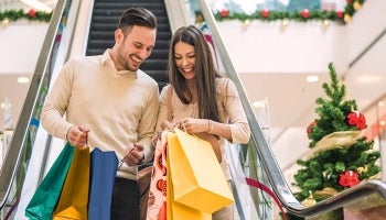 A couple shopping sales on Black Friday with tips from Teachers Federal Credit Union.