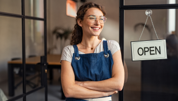 Small business owner standing outside of her commercial-owned property.