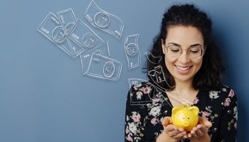 Woman holding a Teachers Federal Credit Union piggy bank and learning how to save money.