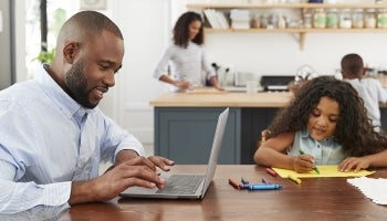 Dad smiling as he reviews his benefits options during open enrollment
