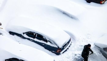 Snow covered cars being dug out after a heavy snowstorm 