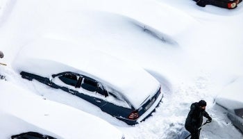 Snow covered cars being dug out after a heavy snowstorm