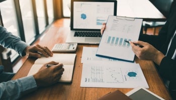 Two people track and analyze spend using a graph