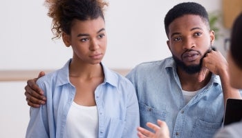 Couple meeting with a loan officer to discuss refinancing