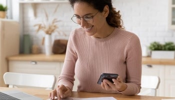 Woman is happy to see that she is staying on track to meet her savings goals