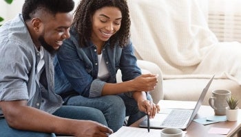 A couple happily reviews finances together