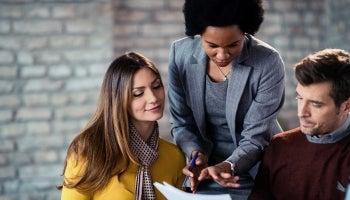 A mortgage loan officer explains the process of obtaining a mortgage to a couple.