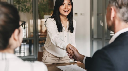 woman shaking man's hand