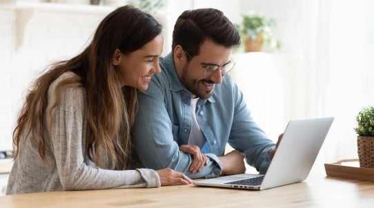 man and woman looking at a computer