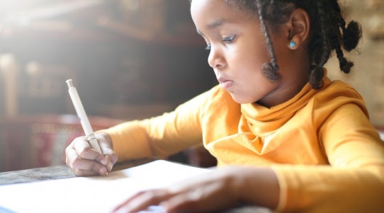 girl writing in a book