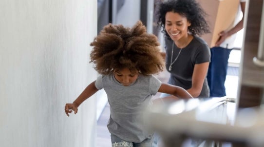 young girl running up stairs