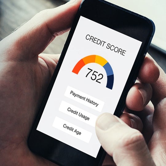 Phone screen showing a credit score with payment history, credit usage and credit age